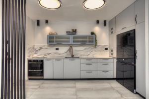 a white kitchen with white cabinets and a sink at Nof Yareach - נוף ירח in Safed +23 photos