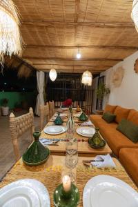 a long table with plates and glasses on it at Riad Dar Lamia Marrakech Médina in Marrakesh