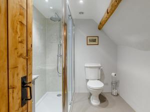 a white bathroom with a toilet and a shower at 3 Bed in Dorchester oc-dc089 in Whitcombe +17 photos