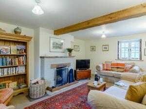 a living room with a couch and a fireplace at 3 Bed in Dorchester oc-dc089 in Whitcombe