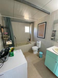a bathroom with a tub and a toilet and a sink at My Olive Tree House in Kalamata +37 photos