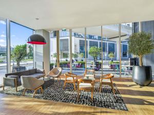 a living room with a couch and chairs and a table at ibis Styles Dubai Airport Hotel in Dubai +37 photos