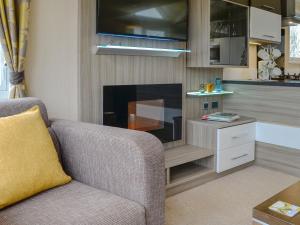 a living room with a couch and a fireplace at Skylark Lodge in Westward