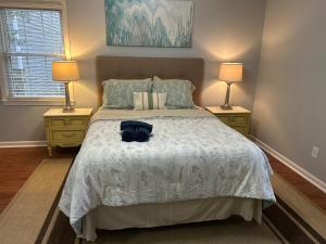 a bedroom with a large bed with two night stands at Under the Oaks, A Downtown Hidden Gem in Wilmington