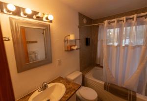 a bathroom with a sink and a toilet and a tub at Williston Lake Resort in Hudson Hope +67 photos