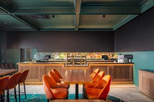 a restaurant with a table and chairs and a bar at The Queens Hotel Gladstone in Gladstone