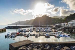 a bunch of boats docked in a harbor at Central Square in Povoação