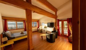 a bedroom with a bed and a television in a room at Williston Lake Resort in Hudson Hope