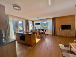 a living room with a kitchen and a dining room at Winzerchalet in Sankt Lambrecht