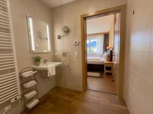 a bathroom with a sink and a shower and a mirror at Winzerchalet in Sankt Lambrecht +43 photos