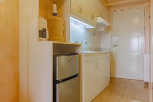 a small kitchen with a stainless steel refrigerator at Meraki Urban in Davao City