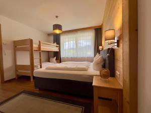 a bedroom with two bunk beds and a desk at Winzerchalet in Sankt Lambrecht