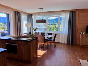 a kitchen and dining room with a table and chairs at Winzerchalet in Sankt Lambrecht