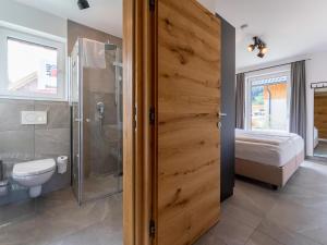a bathroom with a shower and a toilet and a bed at Mountain Chalet An der Mur in Sankt Lorenzen ob Murau +62 photos