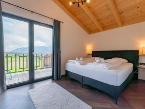a bedroom with a bed and a large window at Obermöschach 10A in Obermöschach