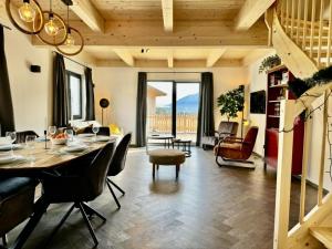 a dining room and living room with a table and chairs at Obermöschach 10B in Obermöschach
