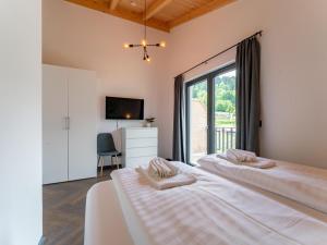 a bedroom with two beds and a window at Obermöschach 10 in Obermöschach