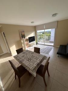 a dining table and chairs in a living room at Portal del Sol in Junín