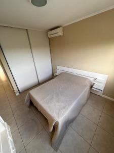 a small bedroom with a bed in a room at Portal del Sol in Junín +7 photos