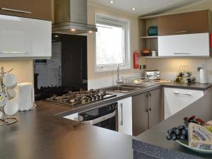 a kitchen with stainless steel appliances and a counter top at Skylark Lodge in Westward
