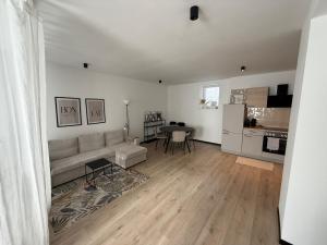 a living room with a couch and a table at Place2stay Gloggnitz2 in Gloggnitz
