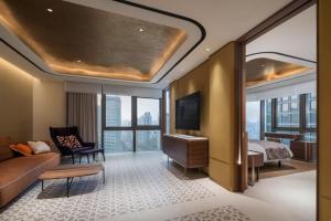 a hotel room with a bed and a living room at 마티네차움호텔 in Seoul