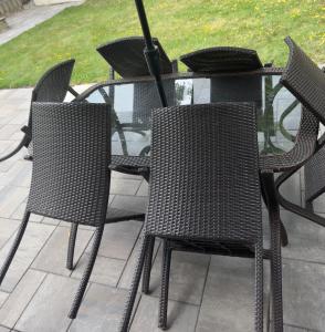 a group of chairs and a table with an umbrella at Joshie Stays in Hamilton