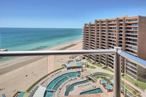 a view of the beach from the balcony of a resort at Las Palomas F-1402 Oceanfront Premium Condo - Sleeps 4 in Puerto Peñasco