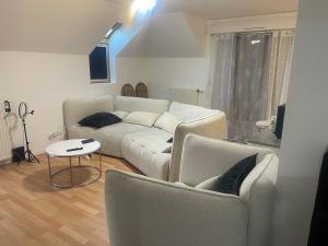 a living room with a couch and two chairs at Lux 1 in Orléans