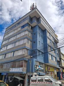 a blue building on the corner of a street at Hotel Rio Mayo in Pasto