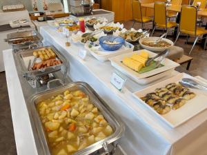 a buffet line with many different types of food at Suizenji Comfort Hotel in Kumamoto