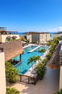 a view of a swimming pool at a resort at Aldea Thai Studios Steps to Beach and 5th Ave in Playa del Carmen