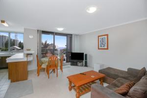 a living room with a couch and a table at Kirra Gardens Unit 9 in Gold Coast
