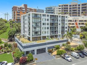 an overhead view of a building with cars parked in a parking lot at Kirra Gardens Unit 9 in Gold Coast