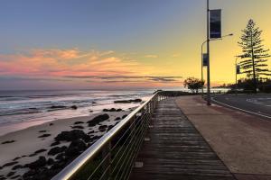 a sidewalk next to a beach with the ocean at Kirra Gardens Unit 9 in Gold Coast +5 photos