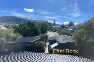 a view of a house with the words east rock at East Rock - Cosy Guesthouse in Kelvin Heights in Queenstown +19 photos