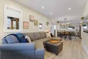 a living room with a couch and a dining room at Spruce Suite Historic NOTL - VINEYARD RETREAT in Niagara-on-the-Lake
