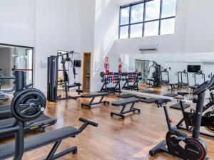 a gym with a bunch of treadms and machines at Flat Palmas Vivence Suítes in Palmas