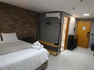 a hotel room with a bed and a closet at Flat Palmas Vivence Suítes in Palmas +8 photos