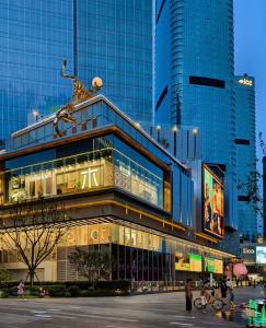 a building in a city with people standing in front of it at ROLA&RICCI Hotel Chengdu East Branch in Chengdu