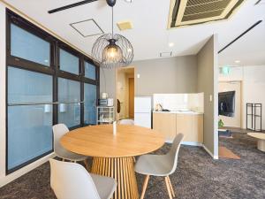 a dining room with a table and chairs at Retrospect Stay Kannai in Yokohama