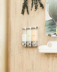 a set of three candles hanging on a wall at Ahra Suites First Floor with ocean view in Kingstown +32 photos