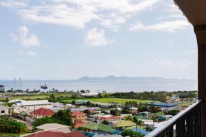 a view of a town from a balcony at Ahra Suites First Floor with ocean view in Kingstown
