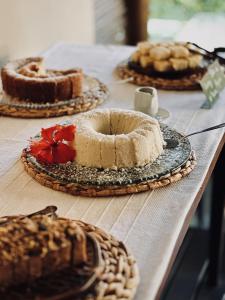 a table topped with different types of cakes and pies at Pousada Erva Doce in Arraial d'Ajuda