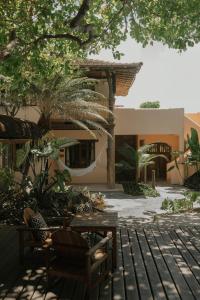 a patio with tables and chairs in front of a building at Pousada Erva Doce in Arraial d'Ajuda