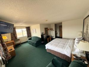 a hotel room with a bed and a tv at Budget inn & Suites in De Witt