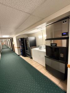 an empty room with a kitchen and a hallway with at Budget inn & Suites in De Witt