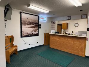 a waiting room with a large picture on the wall at Budget inn & Suites in De Witt