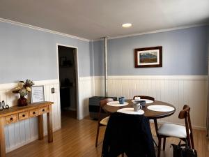 a dining room with a table and chairs at Magnolia Mini House Casa A in Puerto Natales +5 photos