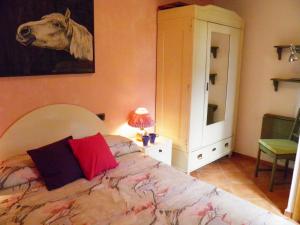 a bedroom with a bed and a picture of a cow on the wall at Rosato in Gravedona +31 photos